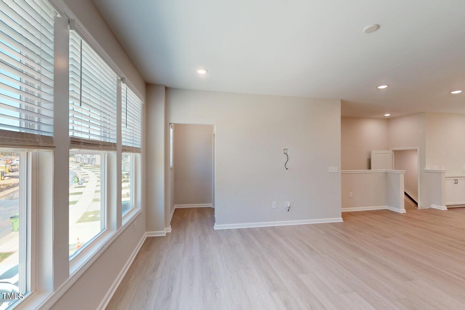 2209 Lambert Road Cary, NC 27519 - Photo 5 of 51 a view of empty room with wooden floor and fan