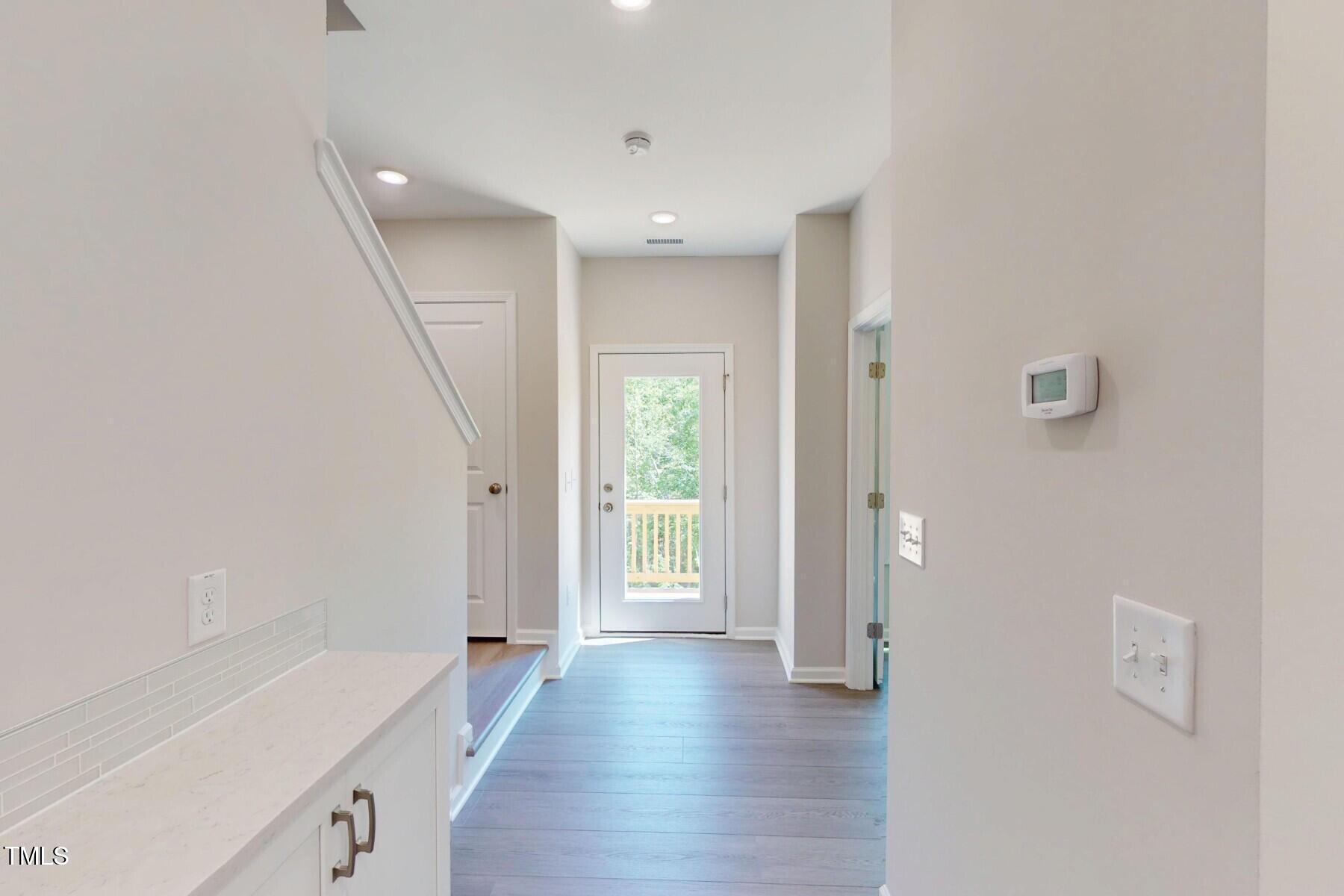 2209 Lambert Road Cary, NC 27519 - Photo 7 of 51 a view of a hallway with wooden floor and cabinet