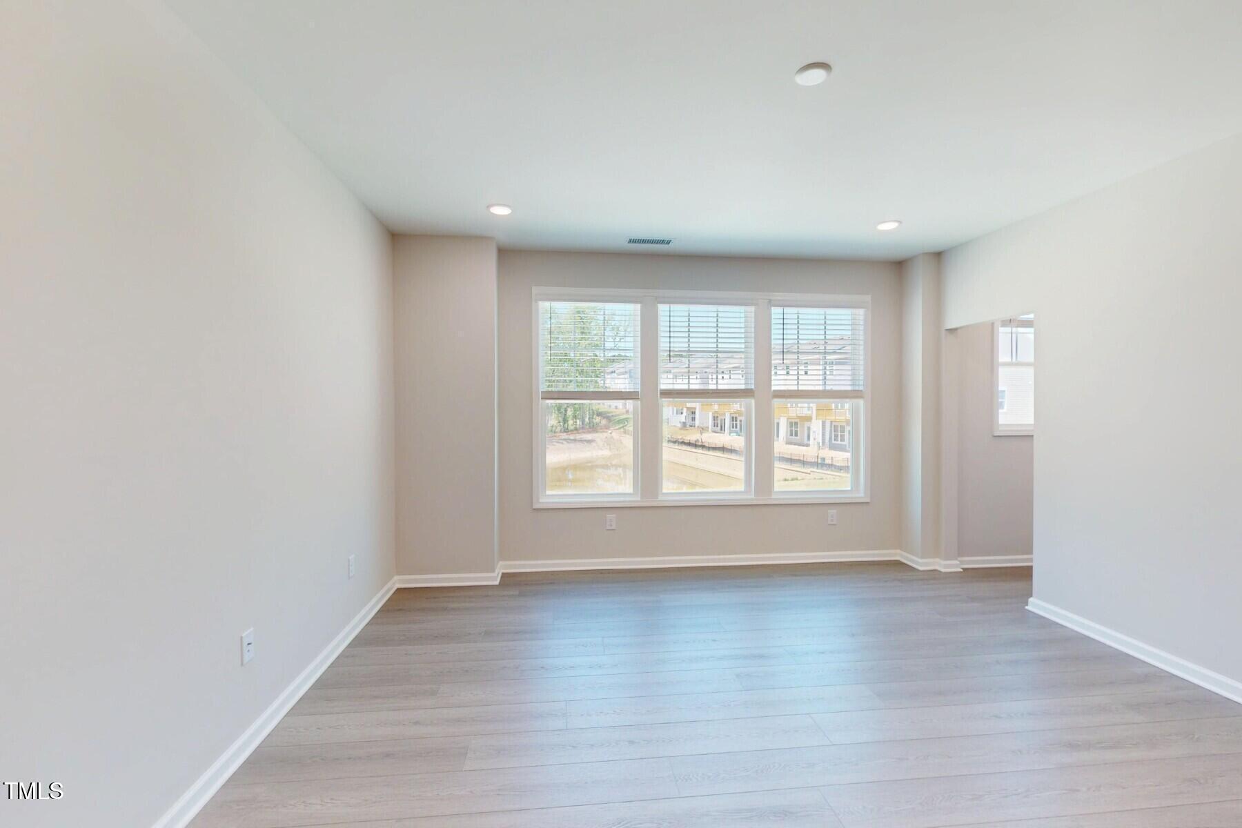 2209 Lambert Road Cary, NC 27519 - Photo 8 of 51 wooden floor in an empty room with a window