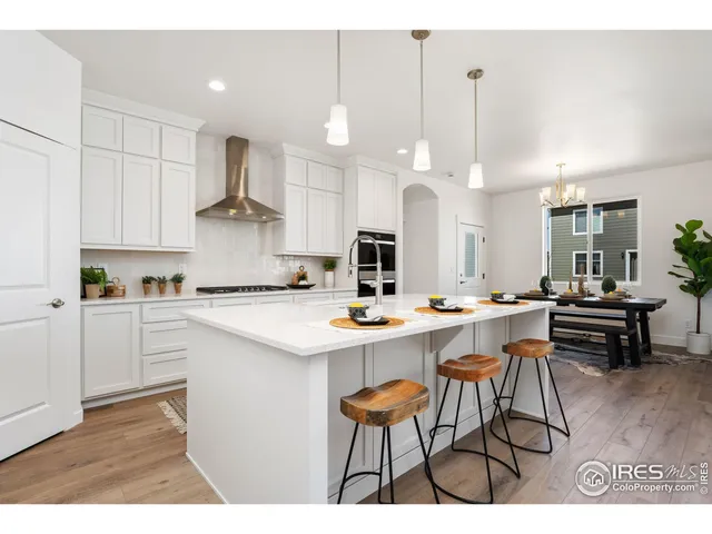 a kitchen with stainless steel appliances kitchen island granite countertop a sink and cabinets