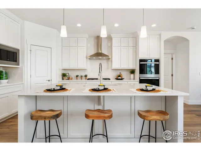 a kitchen with stainless steel appliances a sink and a refrigerator