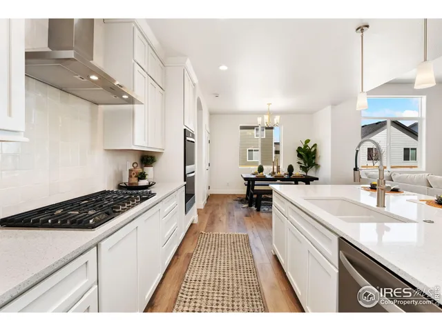 a kitchen with stainless steel appliances a sink stove and cabinets