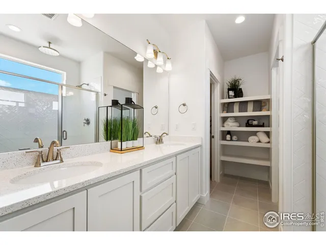 a bathroom with a sink double vanity and a mirror