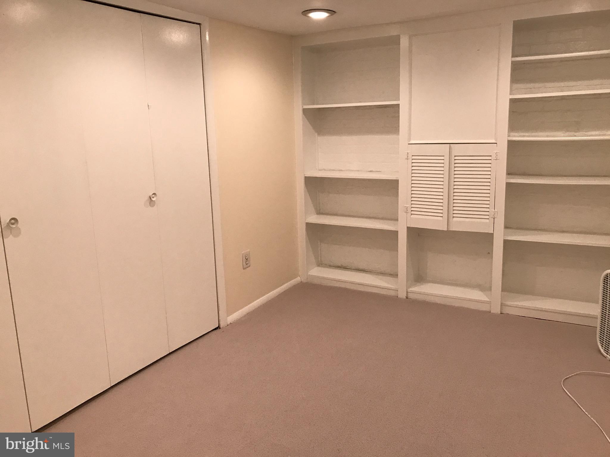 4436 Reservoir Road Northwest Washington, DC 20007 - Photo 23 of 28 Basement bedroom with built in shelves