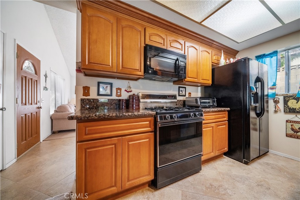 6275 Sapphire Street Rancho Cucamonga, CA 91701 - Photo 11 of 32 a kitchen with stainless steel appliances granite countertop a refrigerator stove and sink