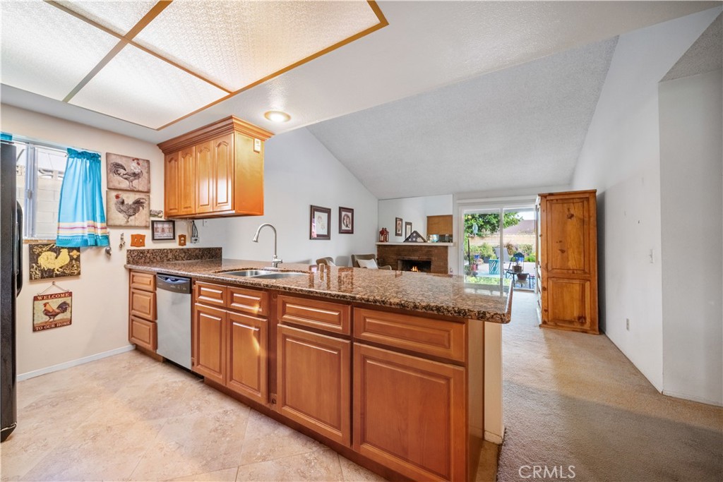 6275 Sapphire Street Rancho Cucamonga, CA 91701 - Photo 12 of 32 a kitchen with stainless steel appliances granite countertop a sink and a refrigerator
