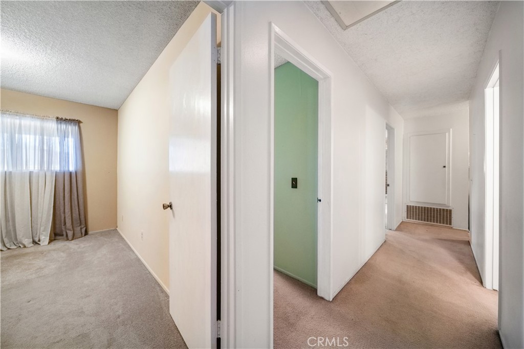 6275 Sapphire Street Rancho Cucamonga, CA 91701 - Photo 21 of 32 a view of a hallway with wooden shelves