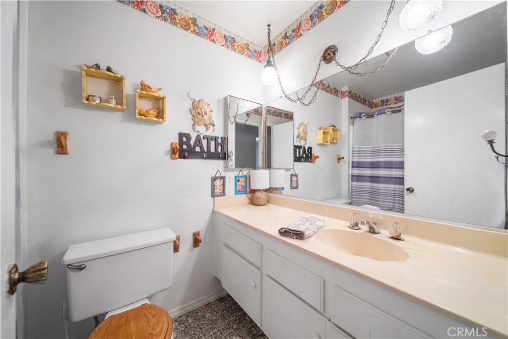 6275 Sapphire Street Rancho Cucamonga, CA 91701 - Photo 24 of 32 a bathroom with a sink a toilet and shower
