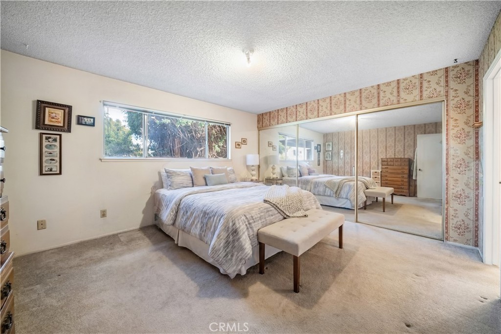 6275 Sapphire Street Rancho Cucamonga, CA 91701 - Photo 25 of 32 a spacious bedroom with a bed a table and large window