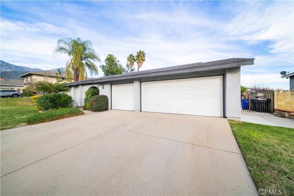 6275 Sapphire Street Rancho Cucamonga, CA 91701 - Photo 30 of 32 a front view of a house with a yard and garage