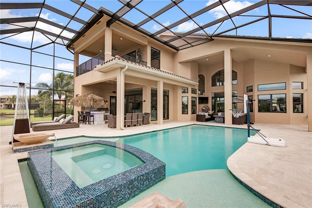 a view of a house with a swimming pool and sitting area
