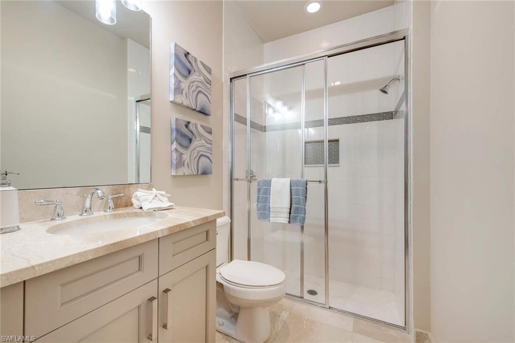 4347 Avalon Court Naples, FL 34119 - Photo 11 of 22 a bathroom with a sink toilet and shower