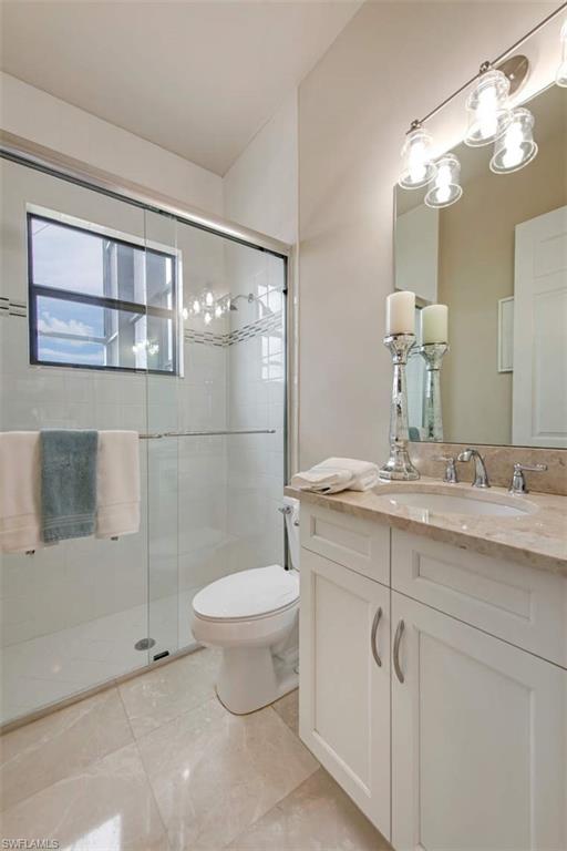 4347 Avalon Court Naples, FL 34119 - Photo 17 of 22 a bathroom with a sink toilet and shower