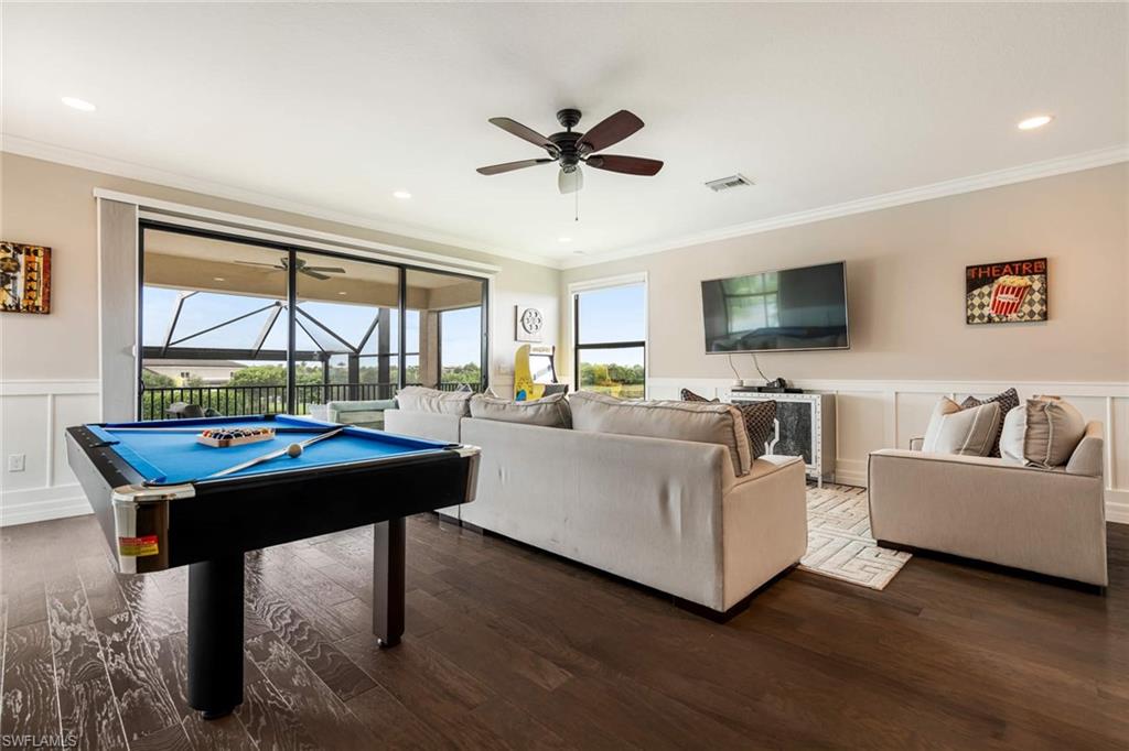 4347 Avalon Court Naples, FL 34119 - Photo 18 of 22 a living room with furniture a rug and a flat screen tv