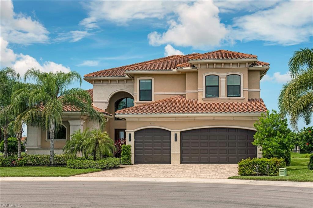 4347 Avalon Court Naples, FL 34119 - Photo 2 of 22 a front view of a house with a yard