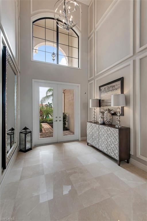 4347 Avalon Court Naples, FL 34119 - Photo 7 of 22 a living room with furniture and a chandelier