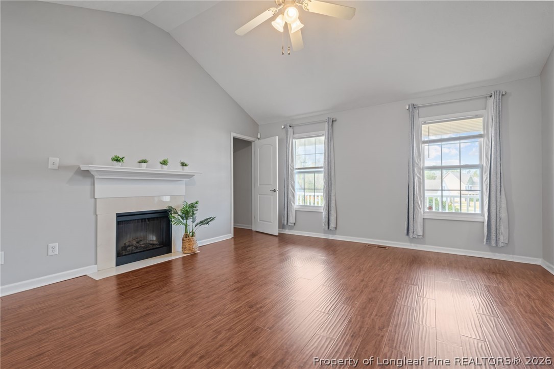 115 Shelby Street Spring Lake, NC 28390 - Photo 8 of 40 wooden floor fireplace and windows in an empty room