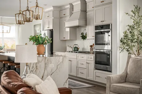 a living room with furniture a fireplace and kitchen view