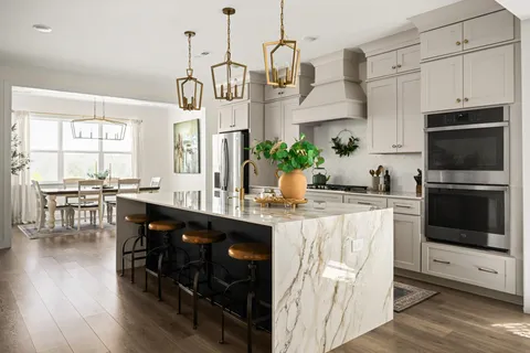 a kitchen with kitchen island granite countertop a stove a sink and a refrigerator