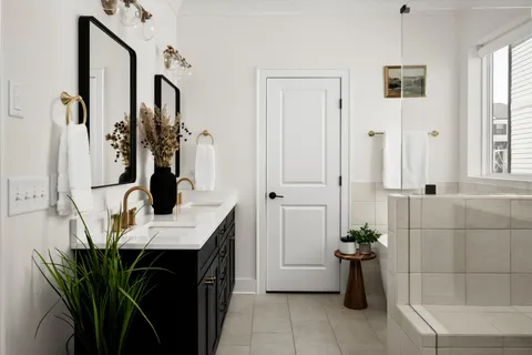 a view of a walk in closet with clothes shoes and a window