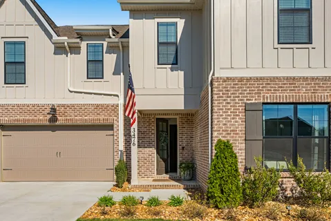 a front view of a house with large windows