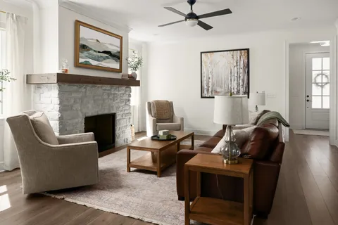 a living room with furniture and a fireplace