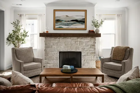 a living room with furniture and a fireplace