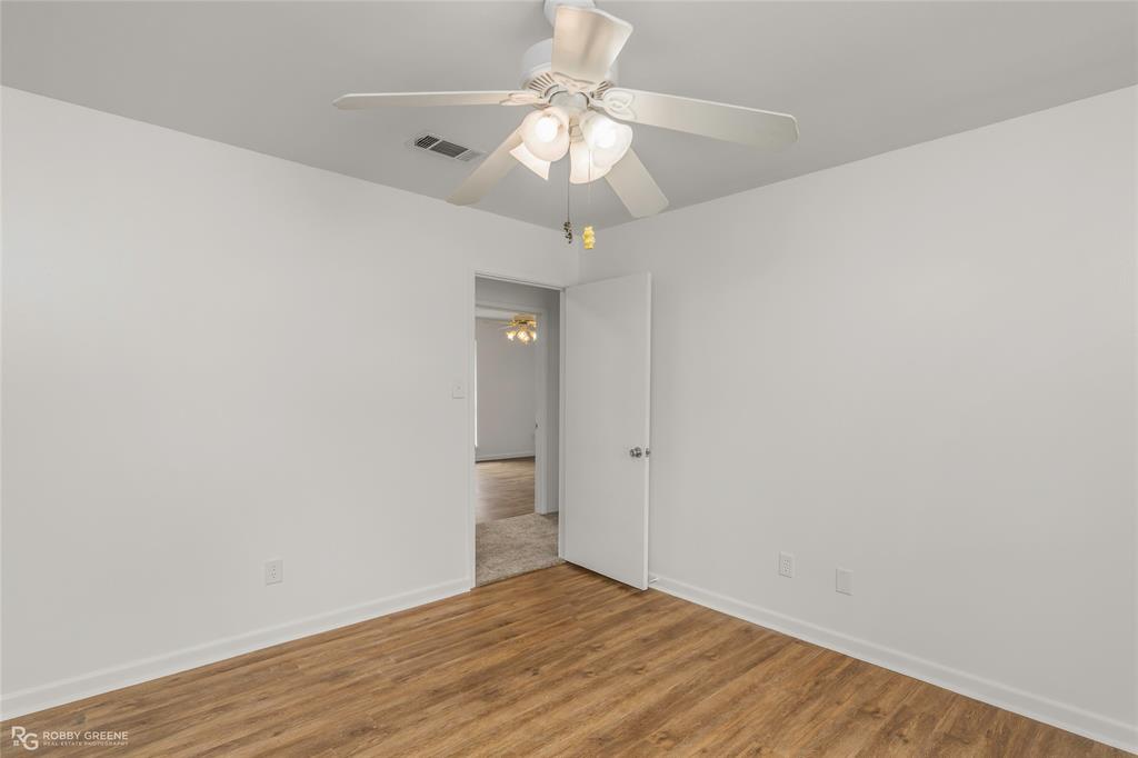 1303 Young Road Benton, LA 71006 - Photo 21 of 34 Unfurnished room with wood finished floors and a ceiling fan