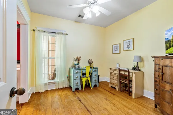 a view of entryway and hall with wooden floor