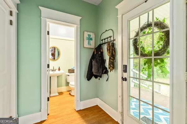 a view of front door and porch with wooden floor