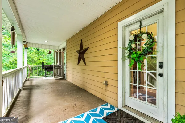 an aerial view of a house with swimming pool and garden