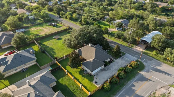 an aerial view of a house with a yard and garden