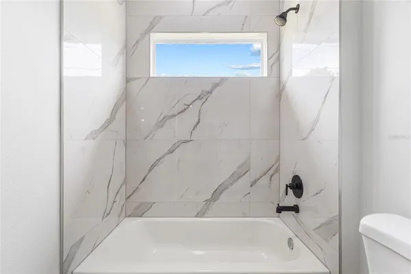 a bedroom with a bed and a chair