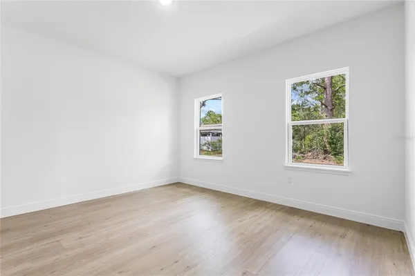 a bathroom with a double vanity sink a mirror and a bathtub