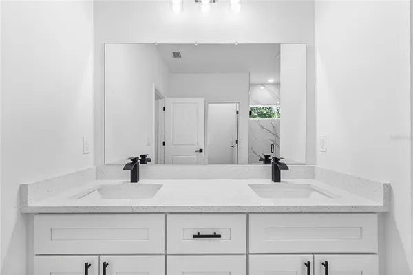 a view of a patio with chairs and table under an umbrella