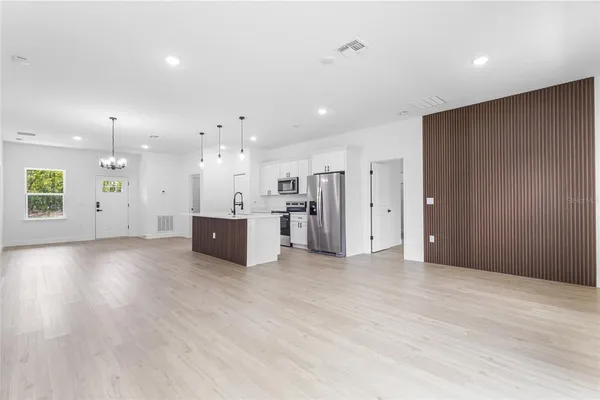 a view of kitchen with cabinets and window