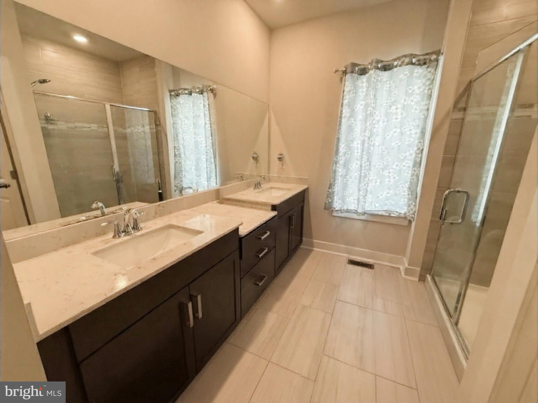 16 Lochiel Lane Exton, PA 19341 - Photo 8 of 19 a spacious bathroom with a double vanity sink a mirror and a bathtub