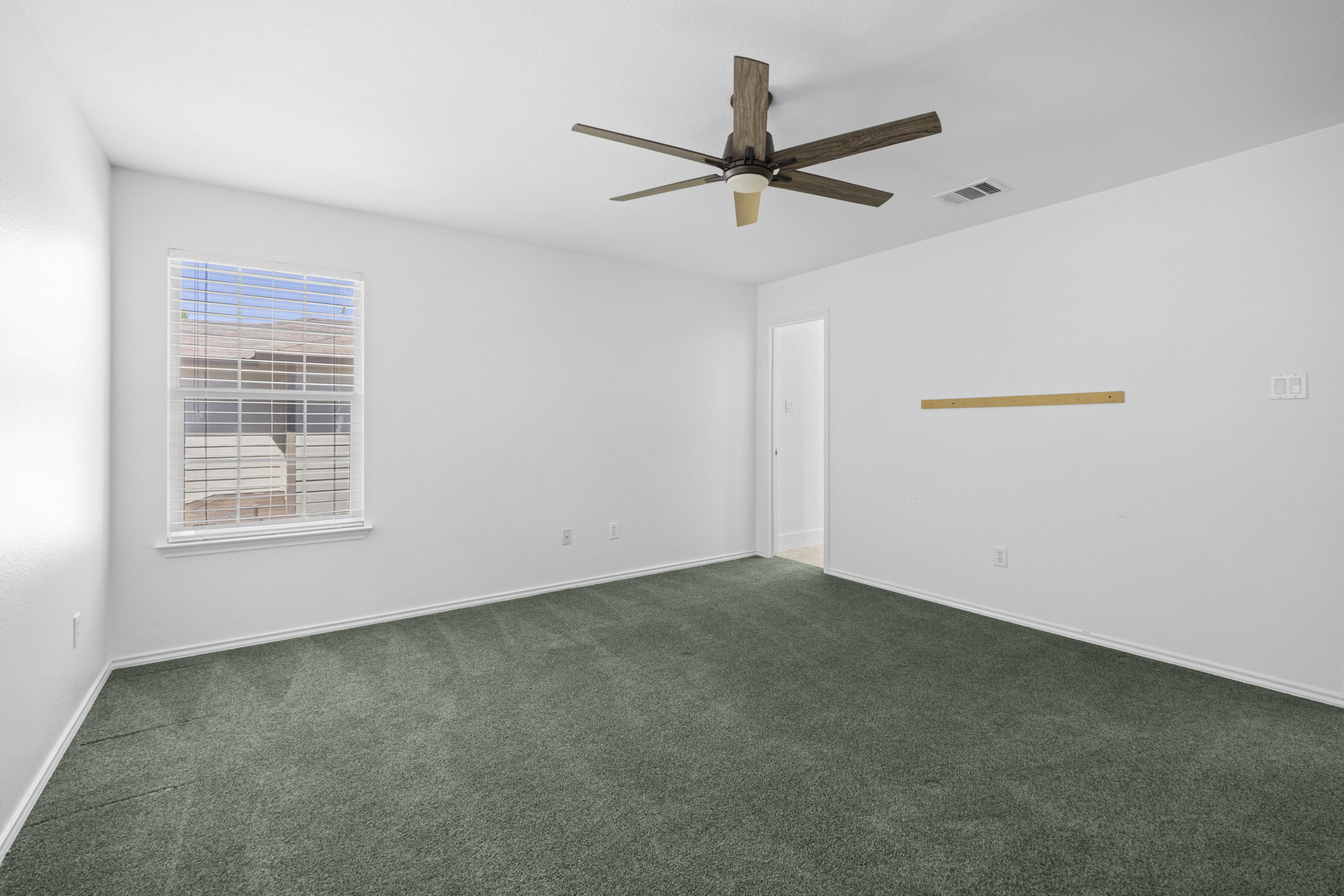 89 Jan Lane Georgetown, TX 78626 - Photo 19 of 29 Empty room with dark colored carpet and a ceiling fan