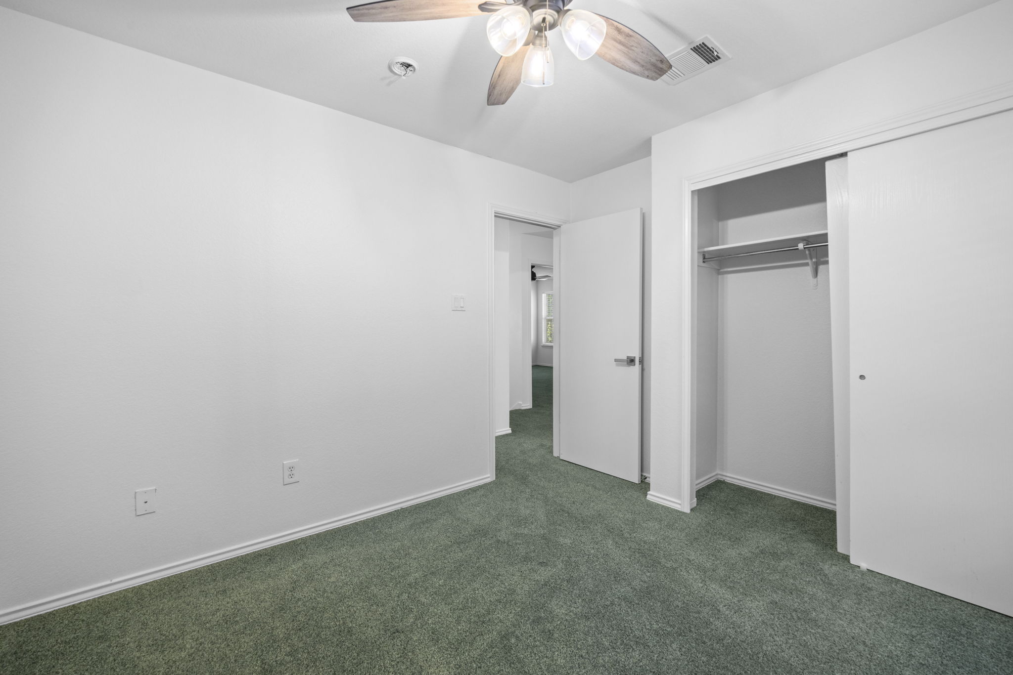 89 Jan Lane Georgetown, TX 78626 - Photo 24 of 29 Unfurnished bedroom with dark carpet, a ceiling fan, and a closet