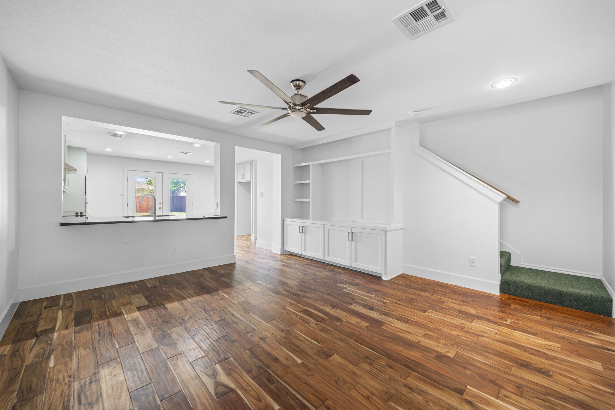 89 Jan Lane Georgetown, TX 78626 - Photo 5 of 29 Unfurnished living room with dark wood finished floors, built in shelves, ceiling fan, and recessed lighting