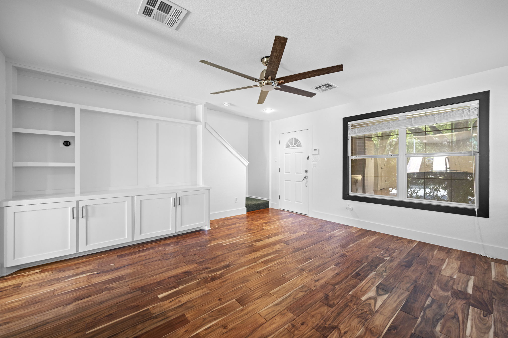 89 Jan Lane Georgetown, TX 78626 - Photo 7 of 29 Unfurnished living room with dark wood finished floors and a ceiling fan
