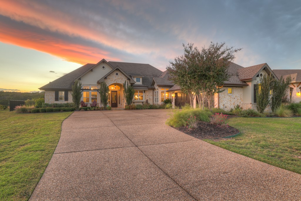 9502 San Lucas Road Austin, TX 78737 - Photo 1 of 1 a front view of a house with a yard and potted plants