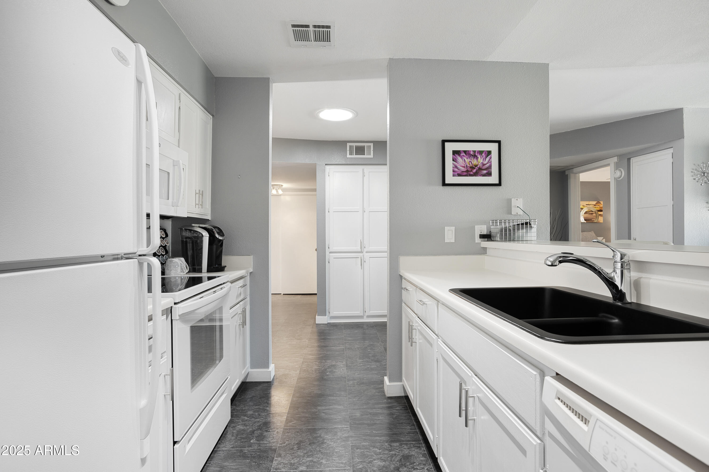1021 South Greenfield Road, Unit 1195 Mesa, AZ 85206 - Photo 13 of 41 a kitchen with a sink and a refrigerator