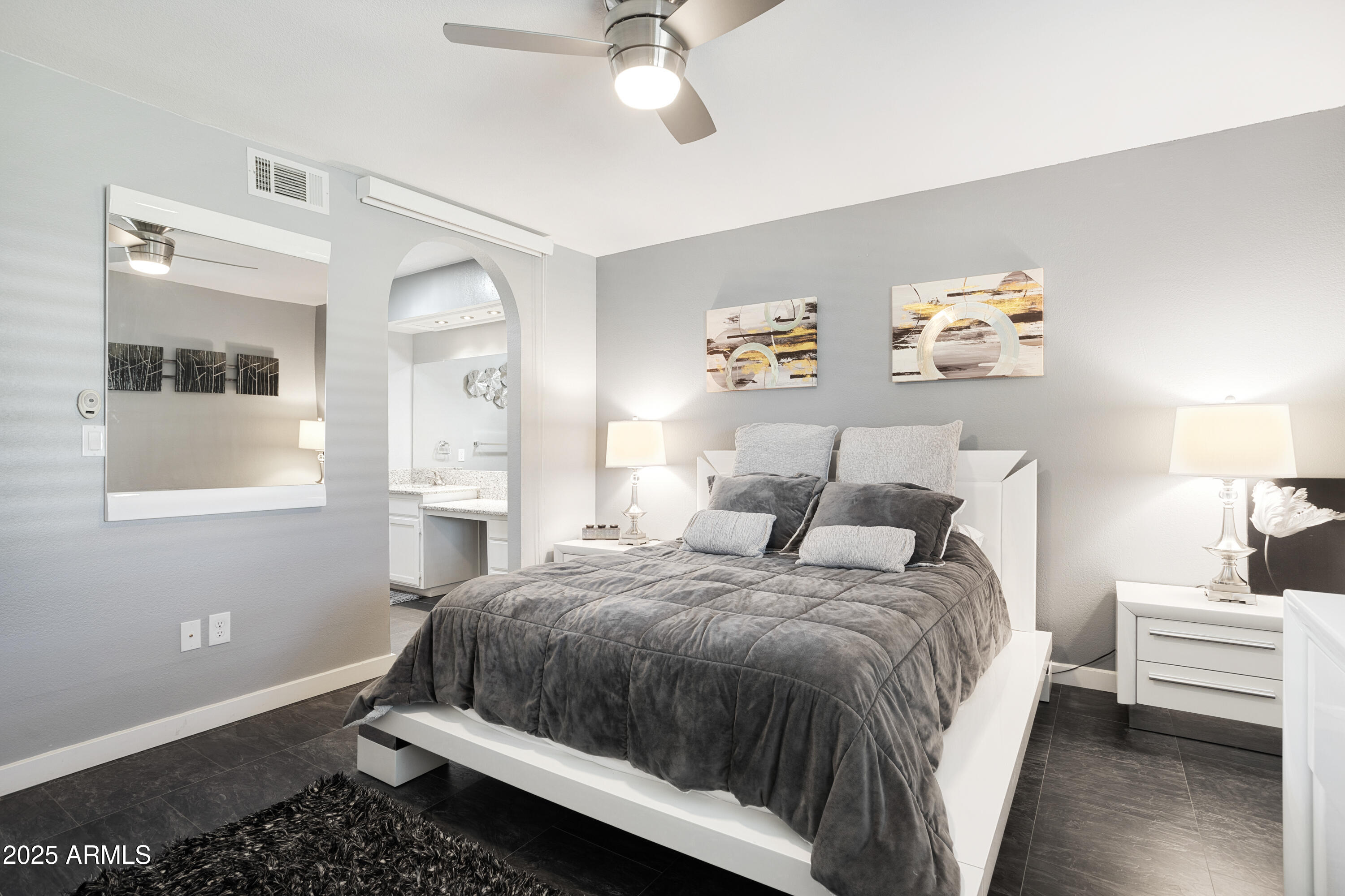 1021 South Greenfield Road, Unit 1195 Mesa, AZ 85206 - Photo 14 of 41 a bedroom with a bed and a chandelier