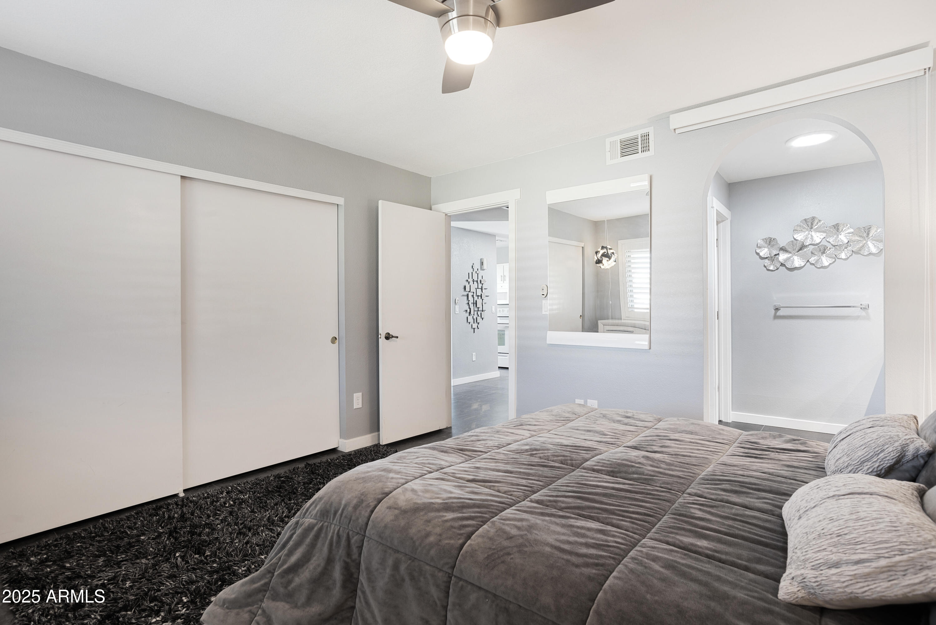 1021 South Greenfield Road, Unit 1195 Mesa, AZ 85206 - Photo 15 of 41 a bedroom with a bed and a chandelier