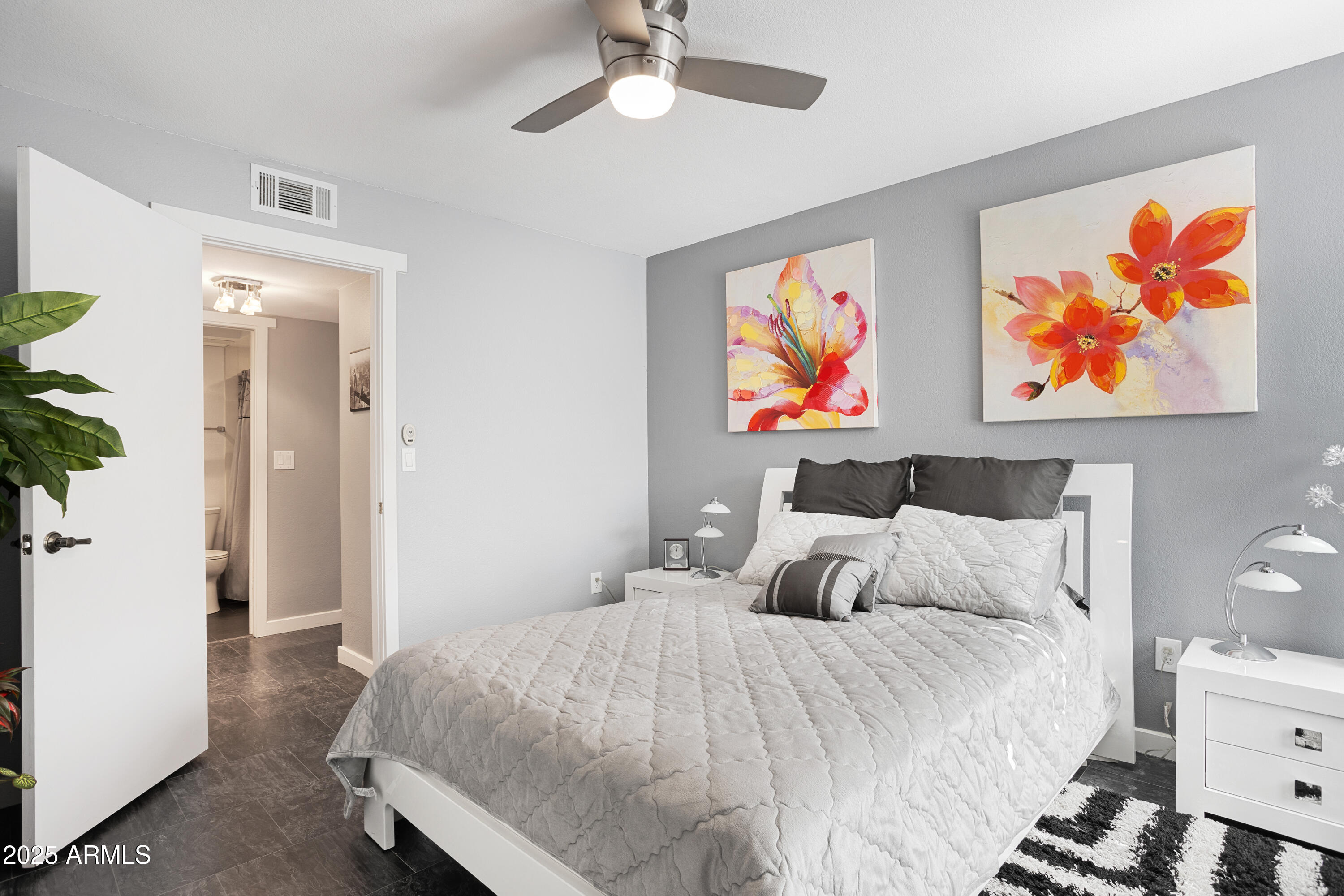 1021 South Greenfield Road, Unit 1195 Mesa, AZ 85206 - Photo 24 of 41 a bedroom with bed and wall painting