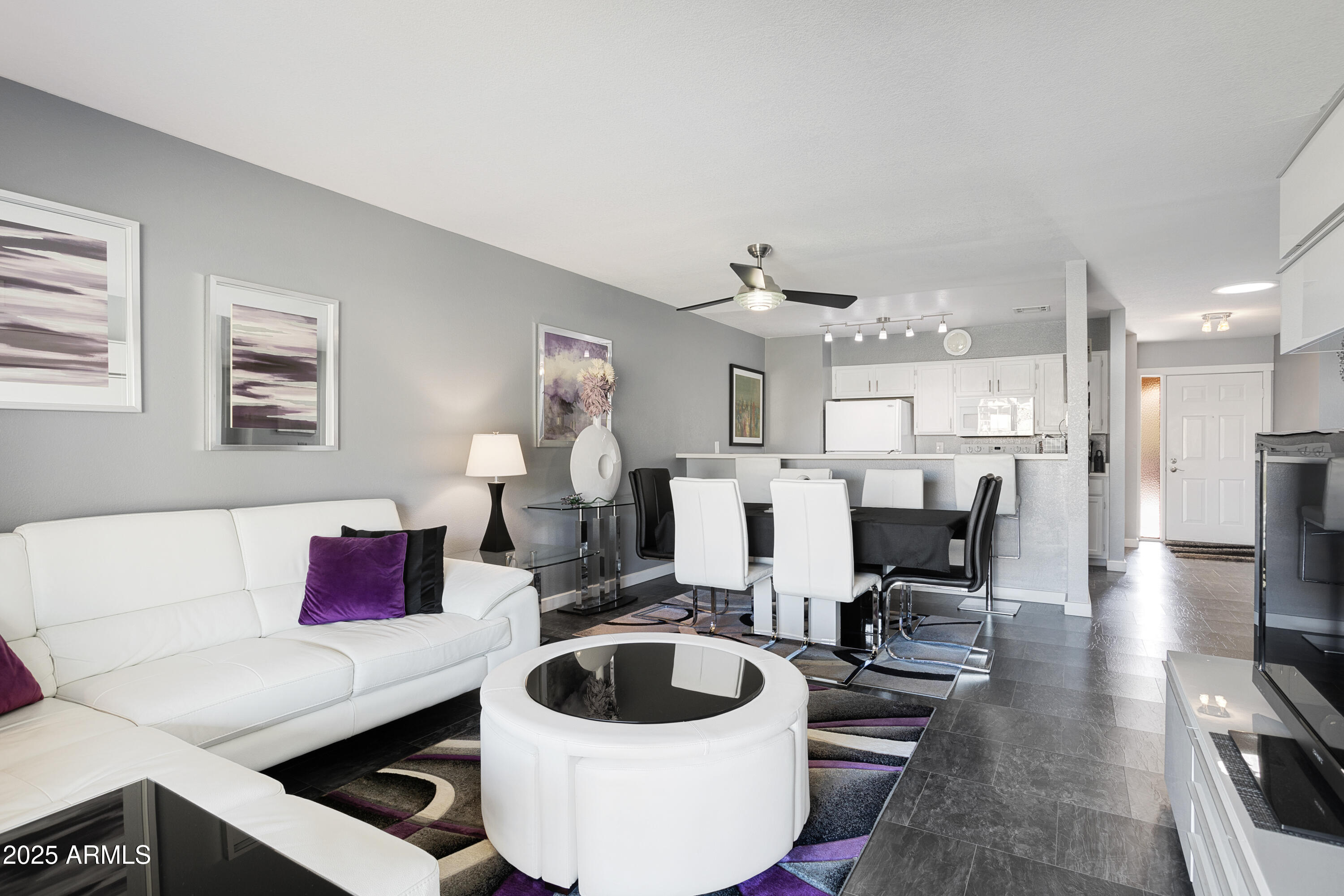 1021 South Greenfield Road, Unit 1195 Mesa, AZ 85206 - Photo 3 of 41 a living room with furniture and a view of kitchen