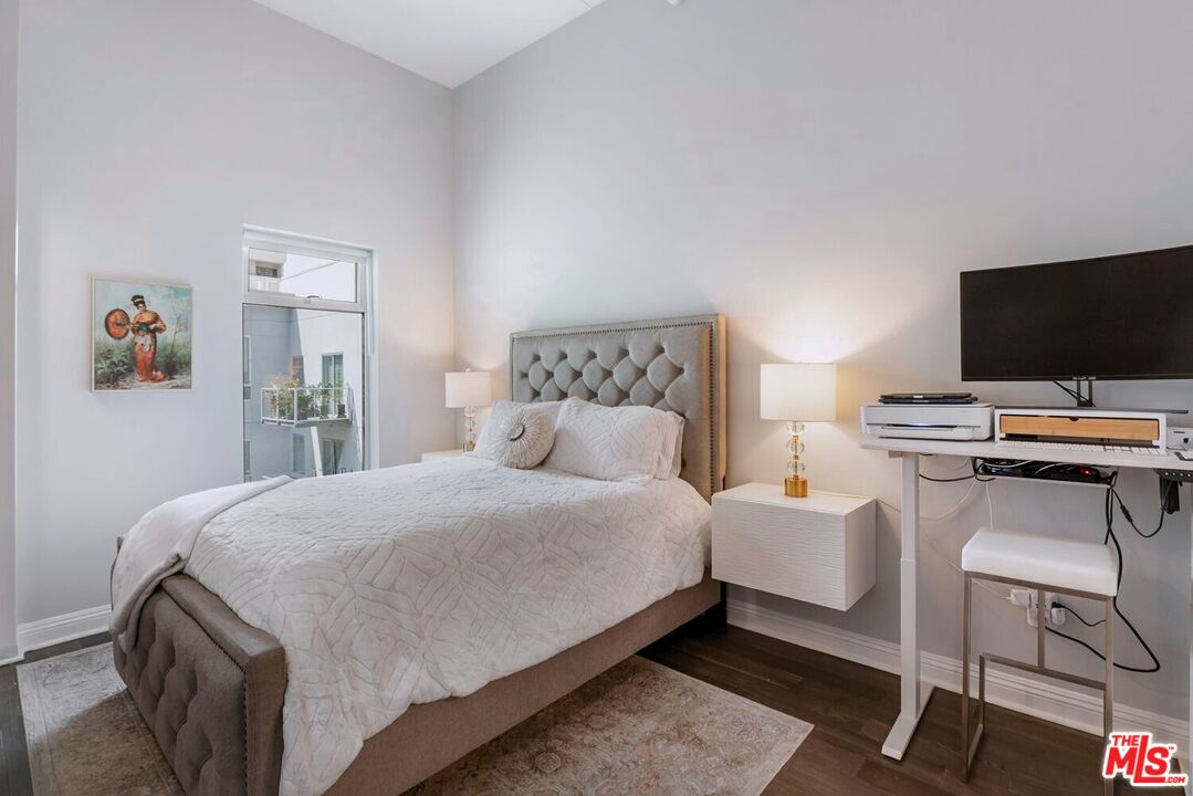 645 West 9th Street, Unit 740 Los Angeles, CA 90015 - Photo 21 of 63 a bedroom with a bed and a flat screen tv