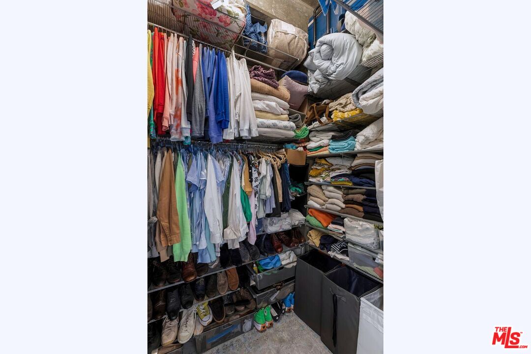 645 West 9th Street, Unit 740 Los Angeles, CA 90015 - Photo 27 of 63 a view of walk in closet with clothes and shoes
