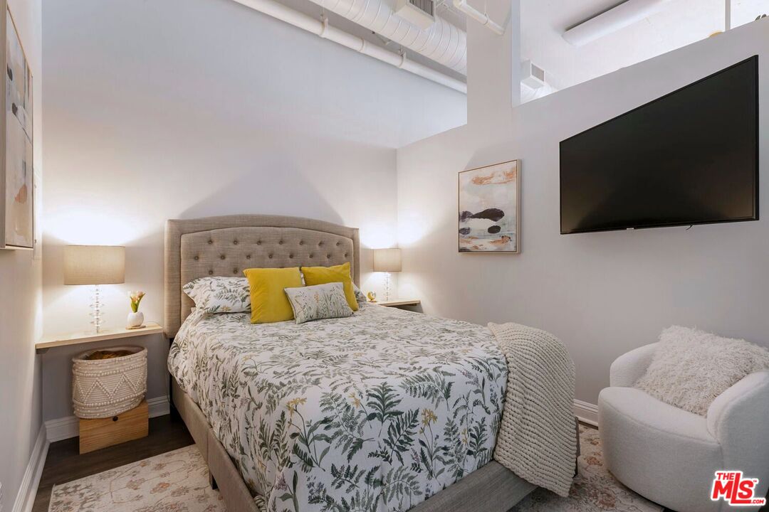 645 West 9th Street, Unit 740 Los Angeles, CA 90015 - Photo 28 of 63 a bedroom with a bed and a flat screen tv